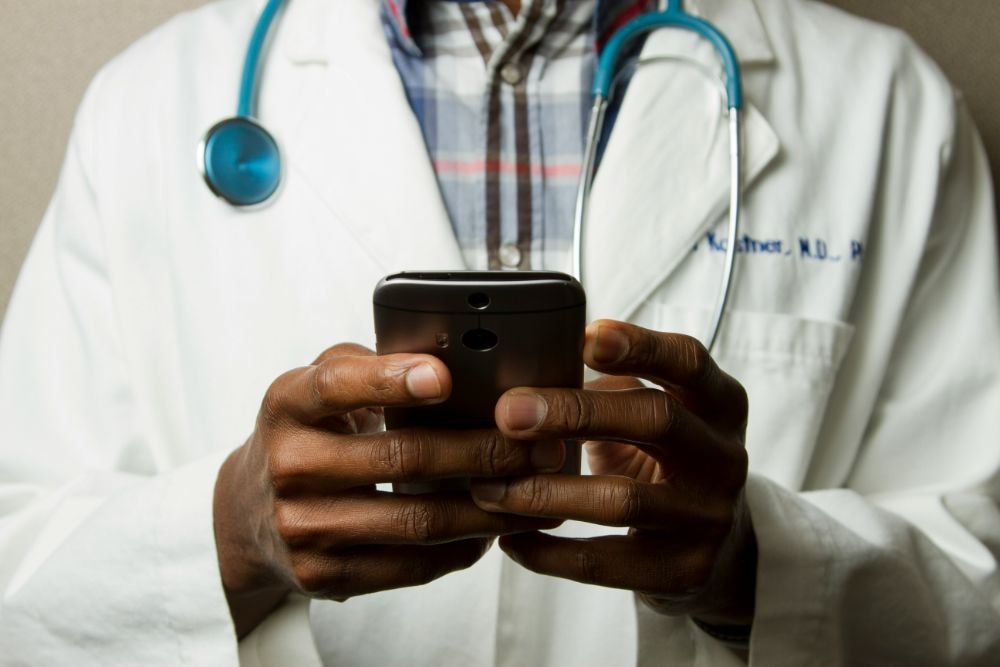 Clinician answering a message on a phone